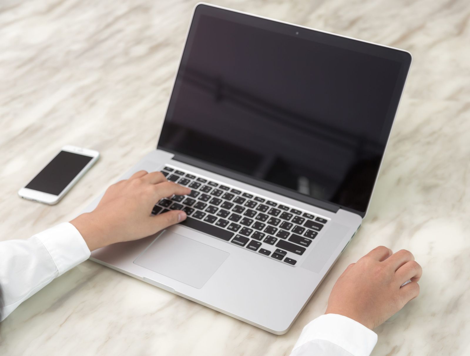 Closeup of business woman hand typing on laptop keyboard